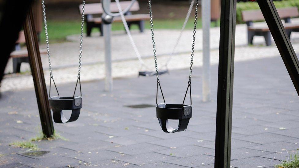 Swings in an empty playground in Romania