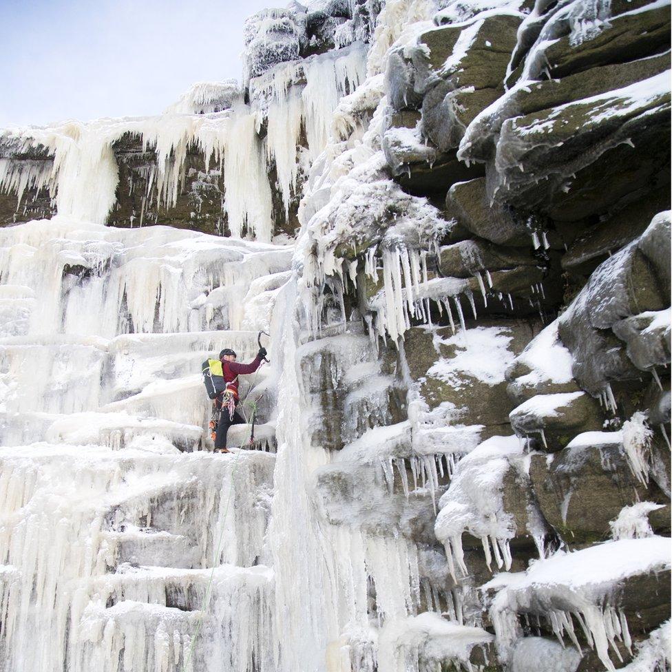 Climber on a frozen over Kinder Downfall