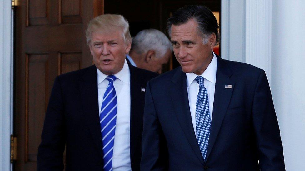 Donald Trump (L) and former Massachusetts Governor Mitt Romney emerge after their meeting at the main clubhouse at Trump National Golf Club