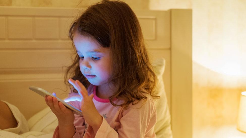 Children looking at phone