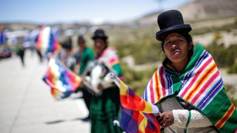 Supporters hold Whipala flags during Bolivia"s former President Evo Morales"s caravan between Uyuni and Oruro, upon his return to the country, in Uyuni, Bolivia November 10, 2020