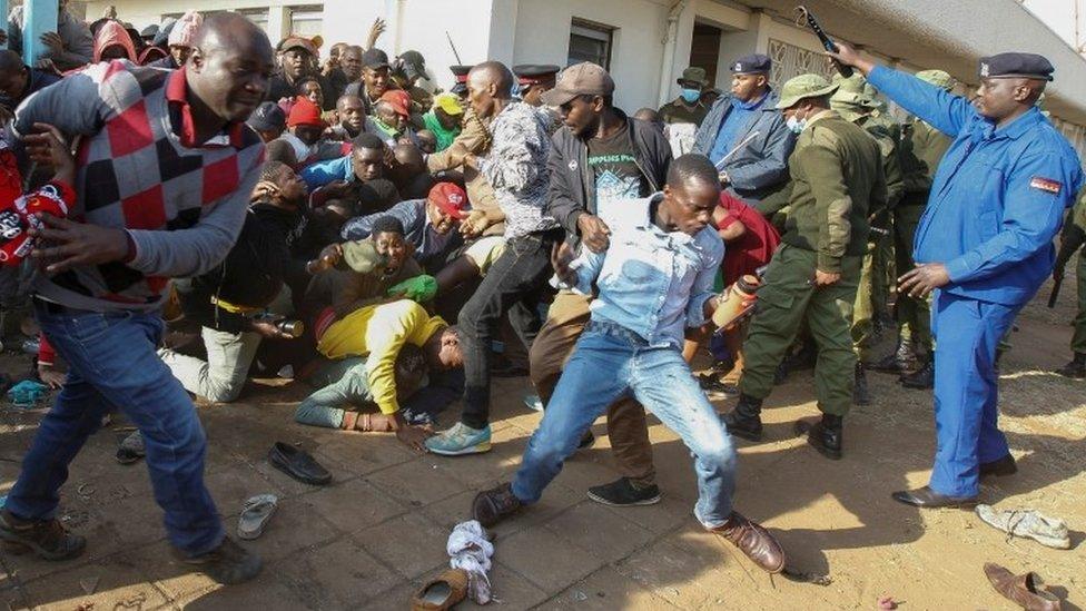 People fall in a stampede as they jostle to attend the inauguration of Kenya"s President William Ruto before his swearing-in ceremony at the Moi International Stadium Kasarani in Nairobi, Kenya September 13, 2022