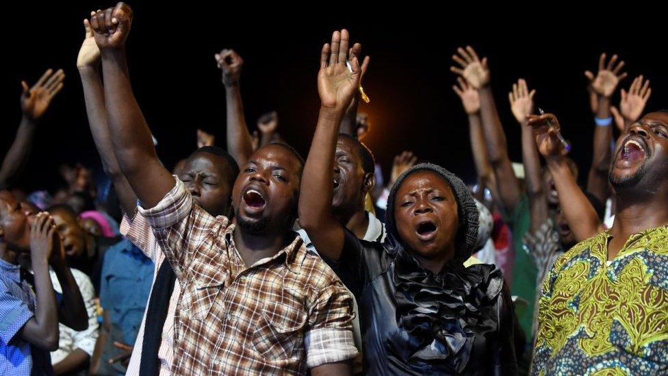 People attend the speech of German pentecostal evangelist Reinhard Bonnke during his "farewell gospel crusade", on November 9, 2017