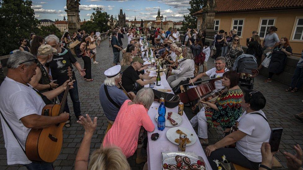 Residents watch live music as they take part in the celebration