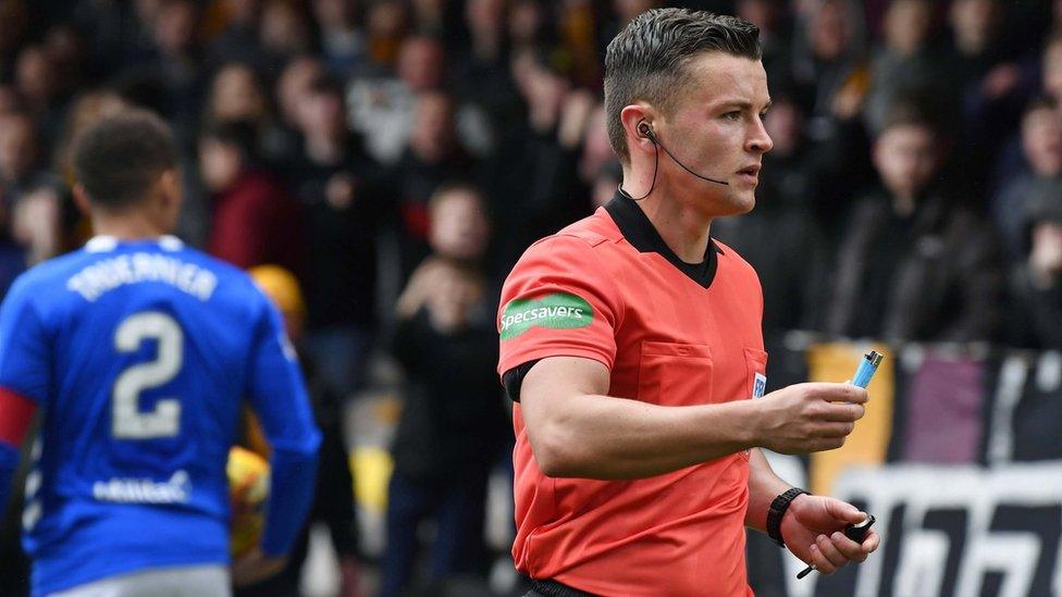 Referee Nick Walsh with the cigarette lighter thrown on to the pitch at Fir Park