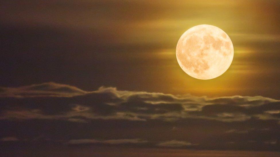 A shot of a bright orange supermoon