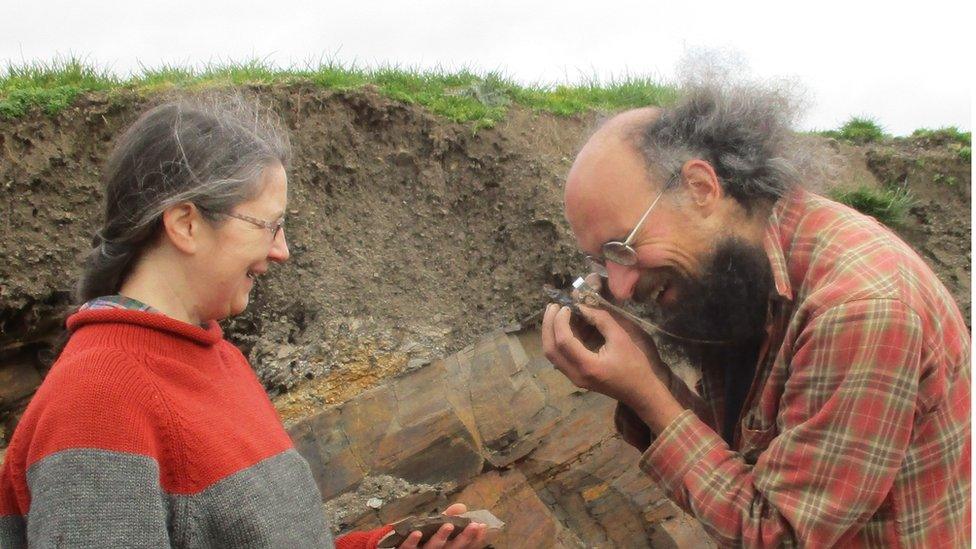 Lucy Muir and Joe Botting examining a fossil specimen at Castle Bank