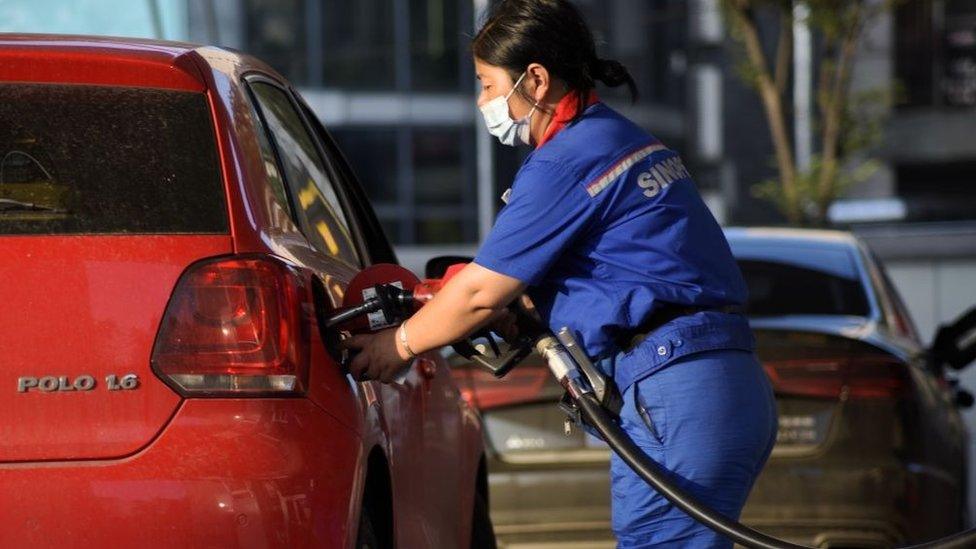 Woman fills up tank