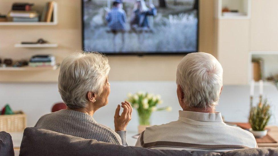 Elderly couple watching TV