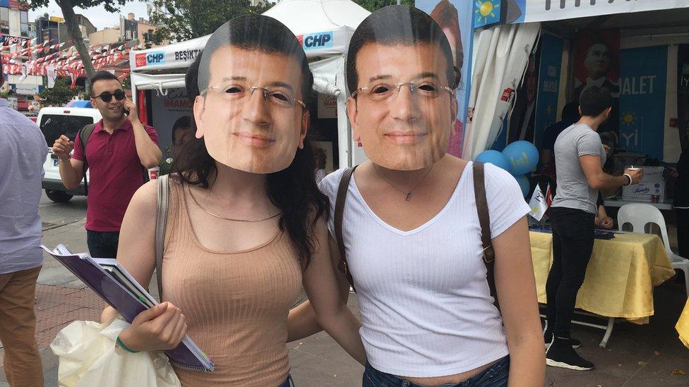 Two women wearing Imamoglu masks