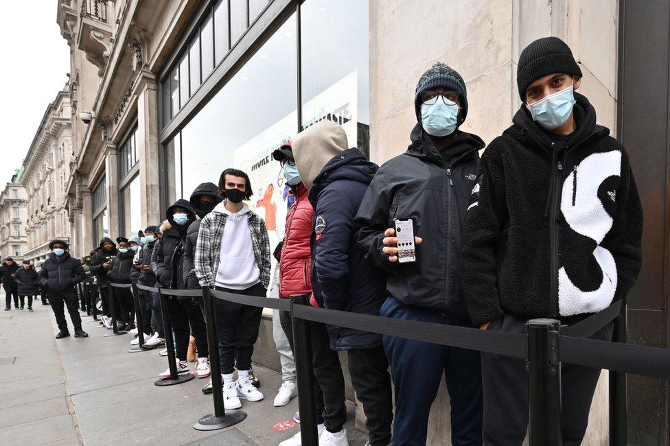 Shoppers queue outside a Nike store in central London