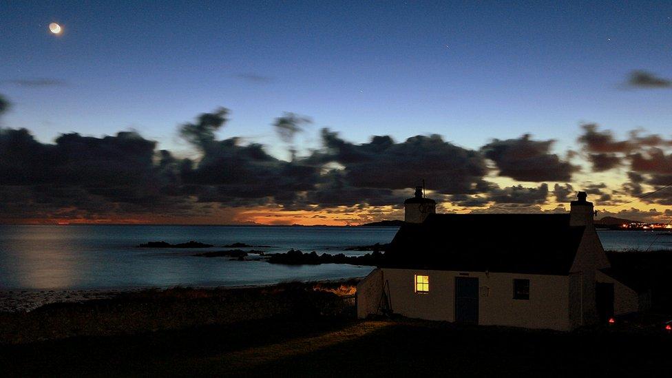 Sunset over a little cottage at Porth Nobla, Anglesey