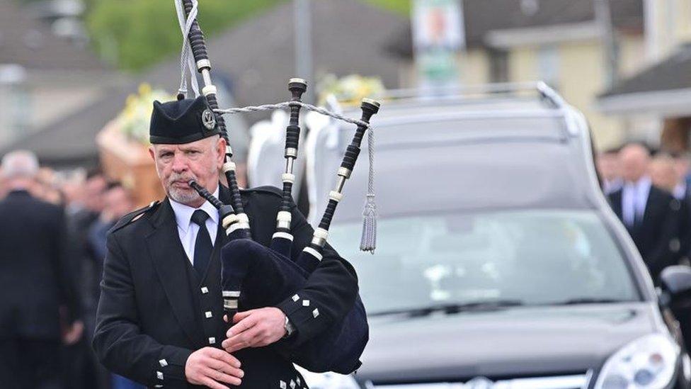 A single piper led a procession of hundreds into The Church of The Immaculate Conception