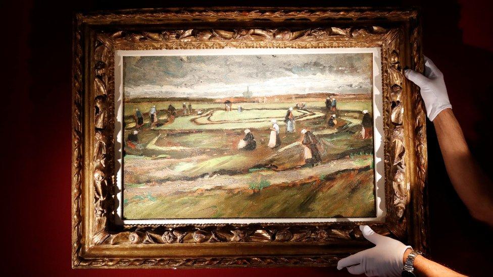 An Artcurial employee poses as he holds the painting Raccommodeuses de filets dans les dunes, 1882.