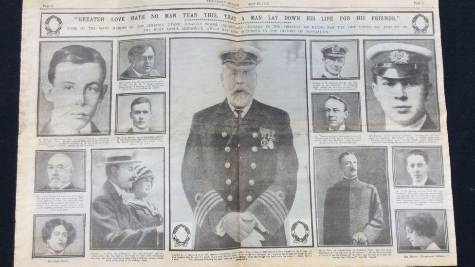 A black and white double page spread of a newspaper featuring photographs of people who were on board the Titanic. In the centre is a large picture of the captain in uniform, including a white peaked hat, double-breasted blazer with four stripes on the cuffs.