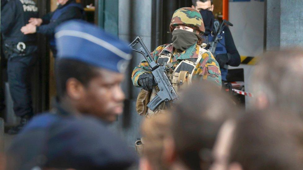 Police control the access to the central train station following bomb attacks in Brussels