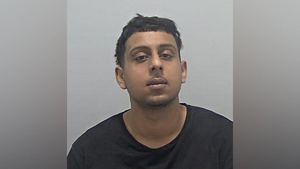 Custody photo of Umer Choudhury