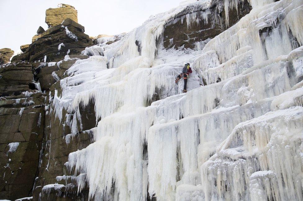 Climber on a frozen over Kinder Downfall