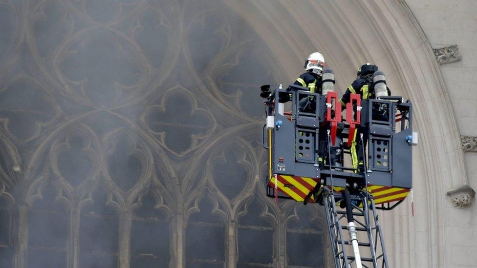 Firefighters us a crane to fight the blaze