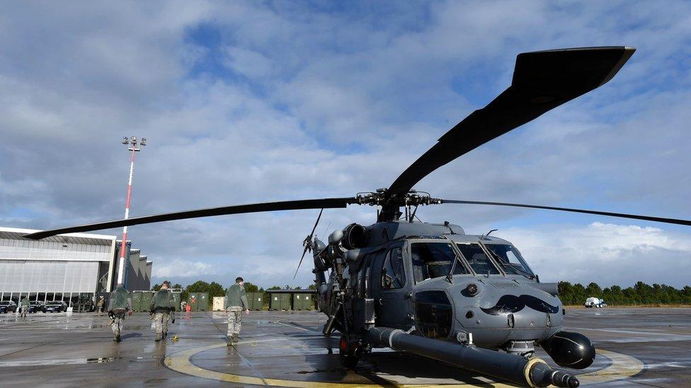 US soldiers walk next to Pavehawk US military helicopter in La Teste-de-Buch.