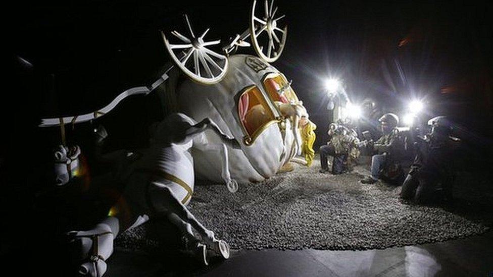 Overturned fairy carriage being photographed