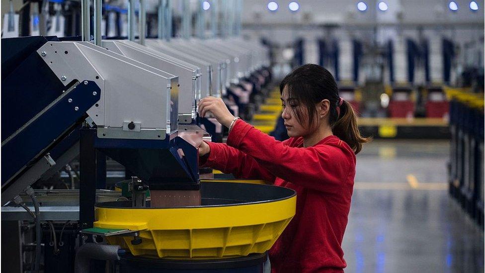 A woman works at a Lego factory in Jiaxing, China