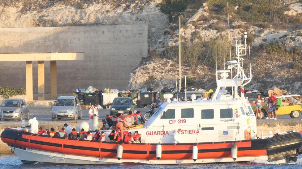 The patrol boat of the Italian Coast Guard is loaded with rescued migrants on its way to disembark at the port in Lampedusa, Italy, 30 August 2020.