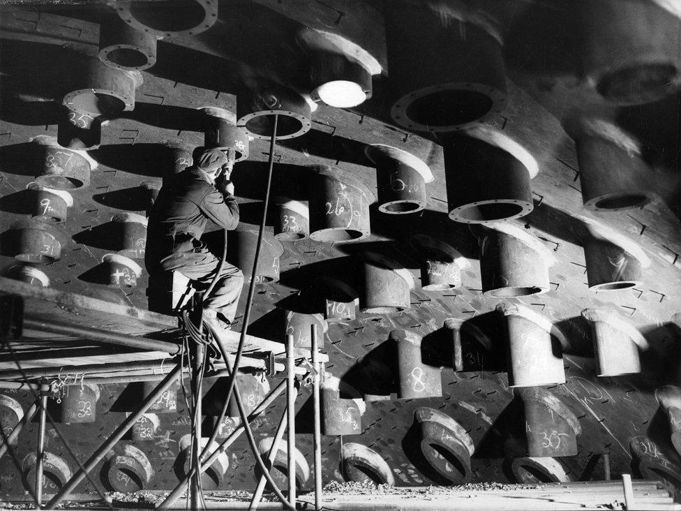 A worker machining control nozzles in the Hinkley Point nuclear power plant in 1961