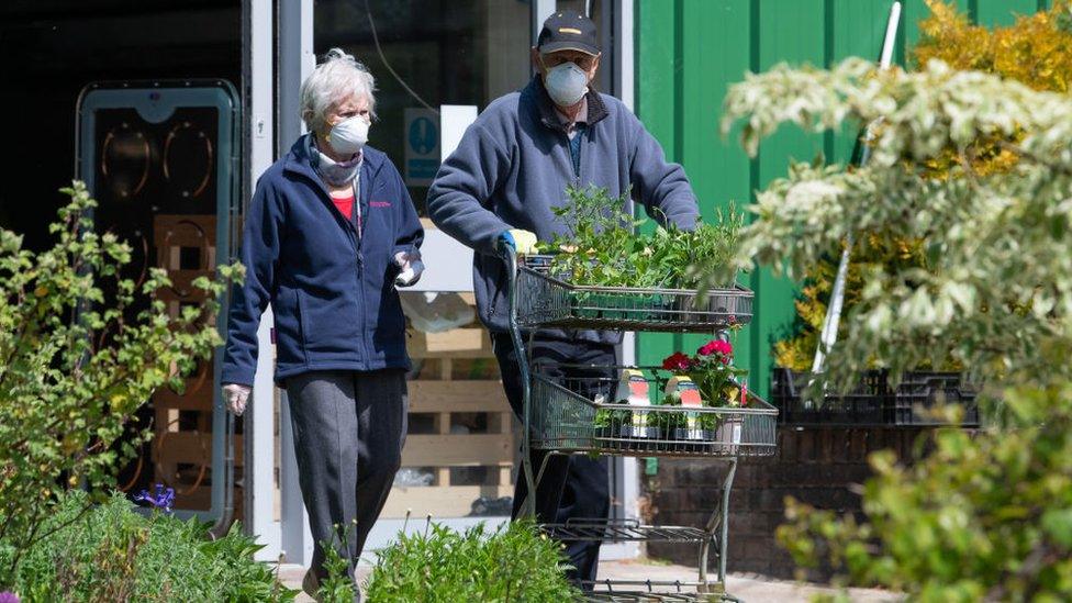 Couple in masks at garden centre