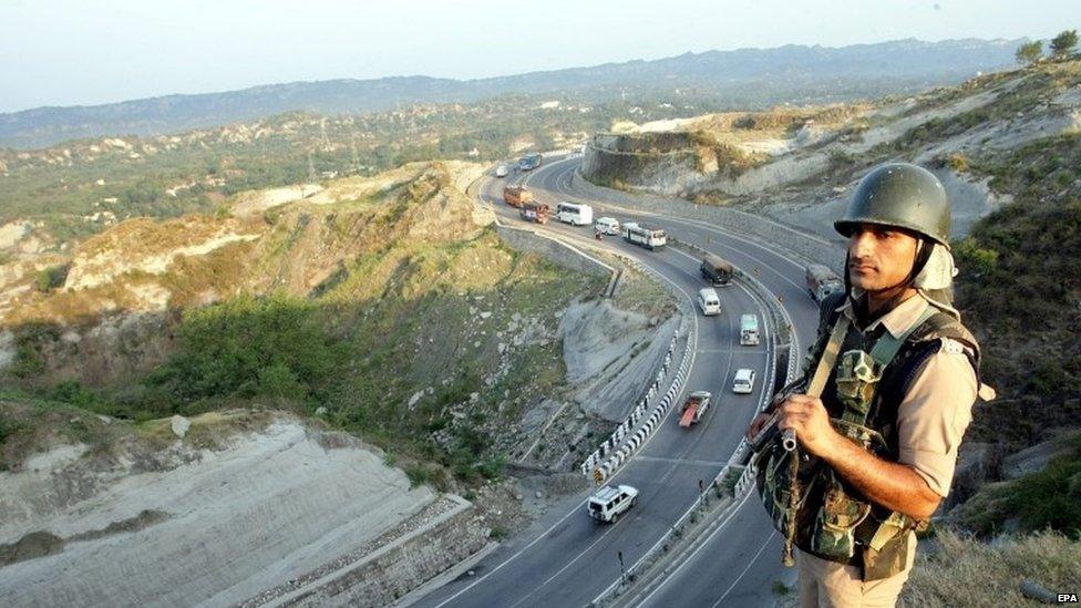 An Indian paramilitary soldier stands guard along the Jammu-Srinagar national highway as Amarnath bound vehicles, the first batch of Amarnath pilgrims on the way to Amarnath Yatra, an annual Hindu pilgrimage to the Amarnath shrine, move along in Jammu, the winter capital of Kashmir, India, 01 July 2015. Thousands of Hindu pilgrims begin an annual pilgrimage on 01 July to the shrine, an icy stalagmite in a mountain cave 4,115 meters (13,500 feet high) above sea level. Hindus worship the stalagmite as an incarnation of the Lord Shiva, the Hindu god of destruction and regeneration.