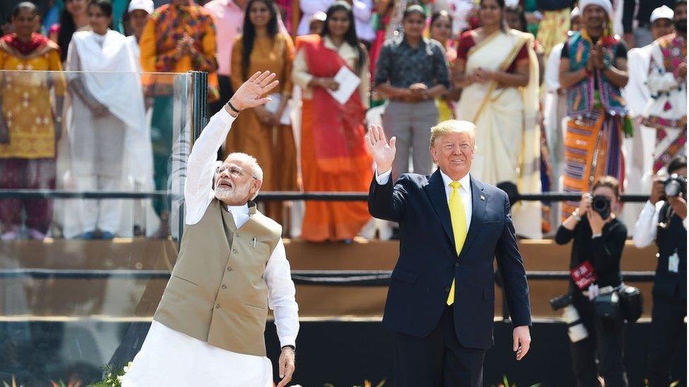 Narendra Modi and Donald Trump wave to the crowd