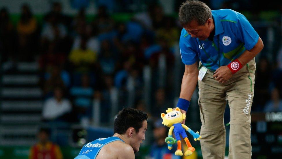 Doszhan Kartikov of Kazakhstan is shown Vinicius by his coach