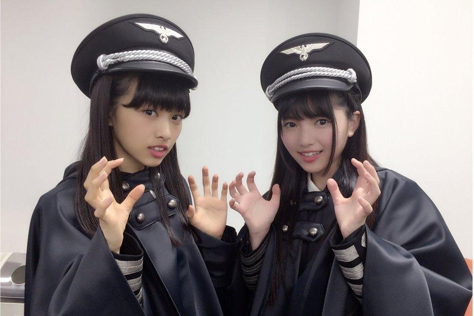 Two members of Keyakizaka46, posing in the costumes