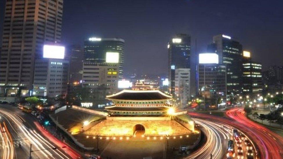 Traffic commuting at night near South Korea"s landmark Namdaemun gate in Seoul