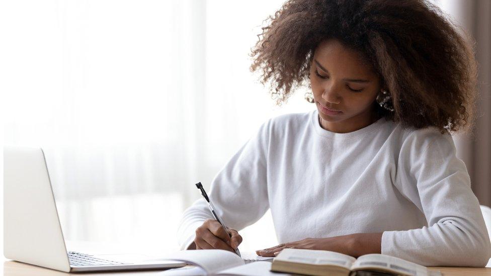 one student sits a test at a computer