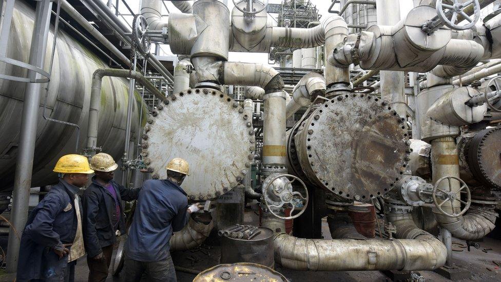 Workers trying to tie a pipe of the first refinery in Nigeria, which was built in 1965 in oil rich Port Harcourt, Rivers State.