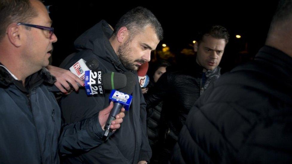 Costin Mincu (centre), one of the owners of the Colectiv nightclub, exits the general prosecutor's office handcuffed in Bucharest, Romania ()2 November 2015