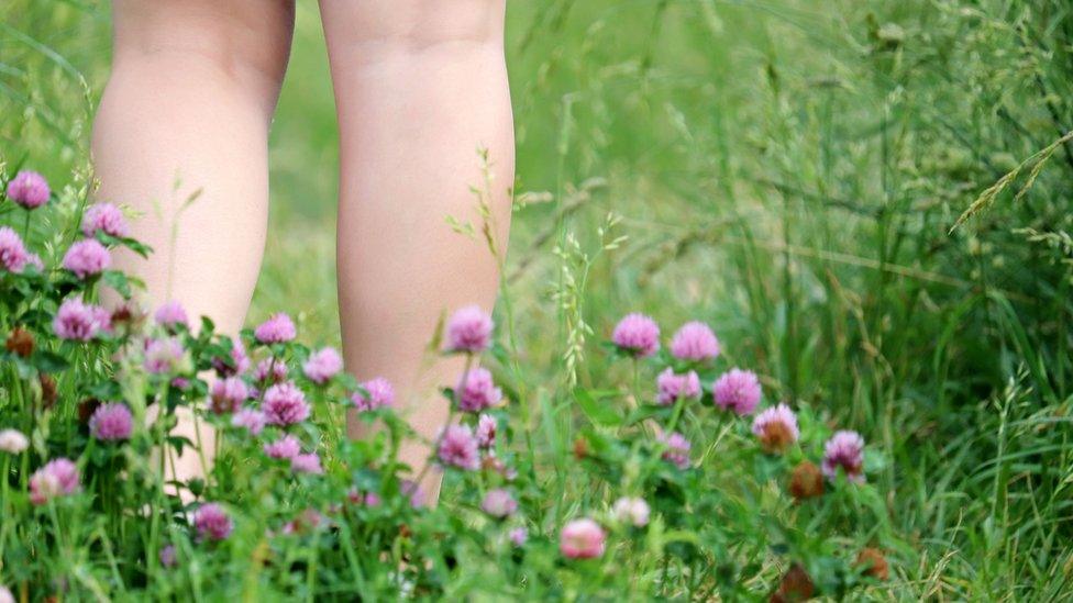 Bare legs in the grass