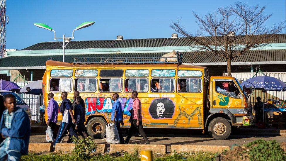 Commuters getting on to a Matatu, or private minibus, in Nairobi