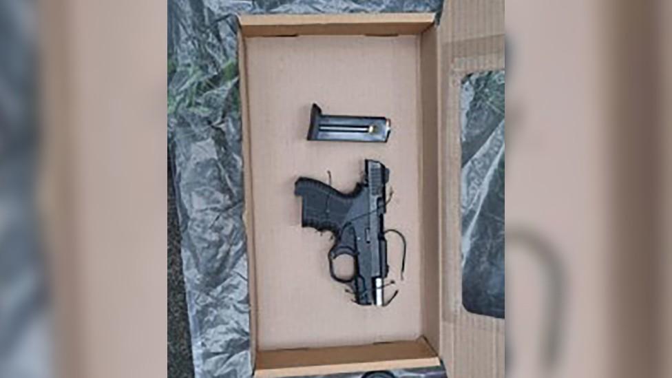 A gun seized during the raid