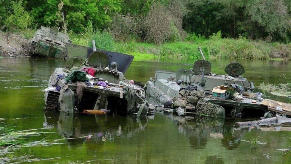 Destroyed Russian vehicles in a river