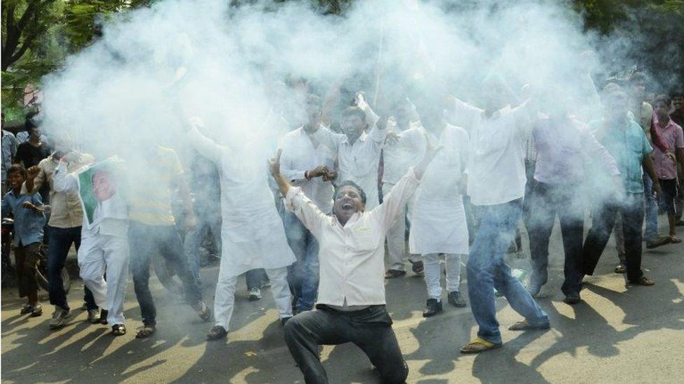 Supporters of an alliance of parties opposed to India's ruling Bharatiya Janata Party light crackers to celebrate as early results of Bihar state elections indicate victory for them in Patna, India, Sunday, Nov. 8, 2015.