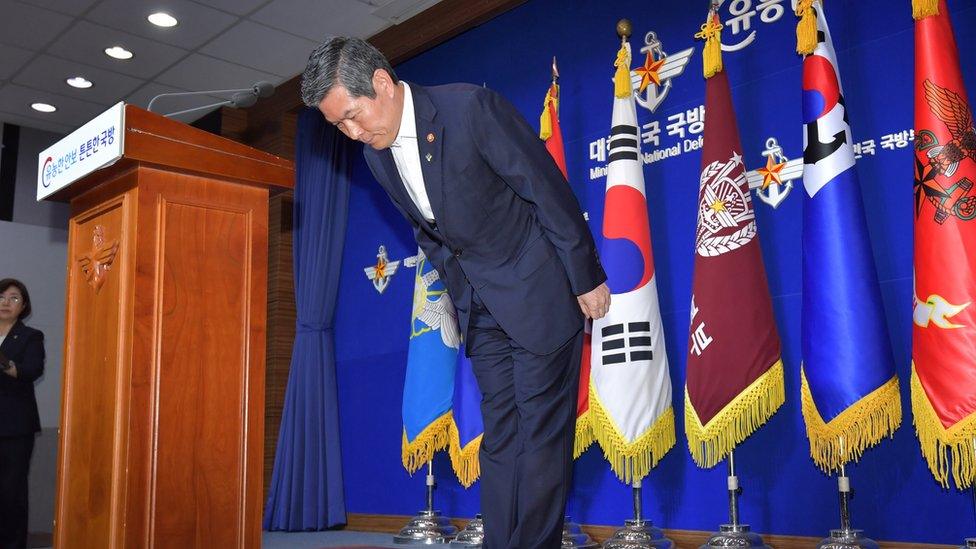 South Korean Defence Minister Jeong Kyeong-doo bows in front of Korean flags at a press conference in June where he offered an apology to citizens over the fishing boat incursion