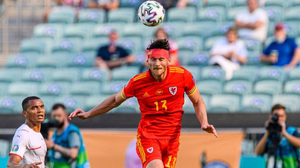 Kieffer Moore of Wales heads the ball