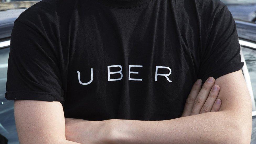 Uber logo written on t-shirt