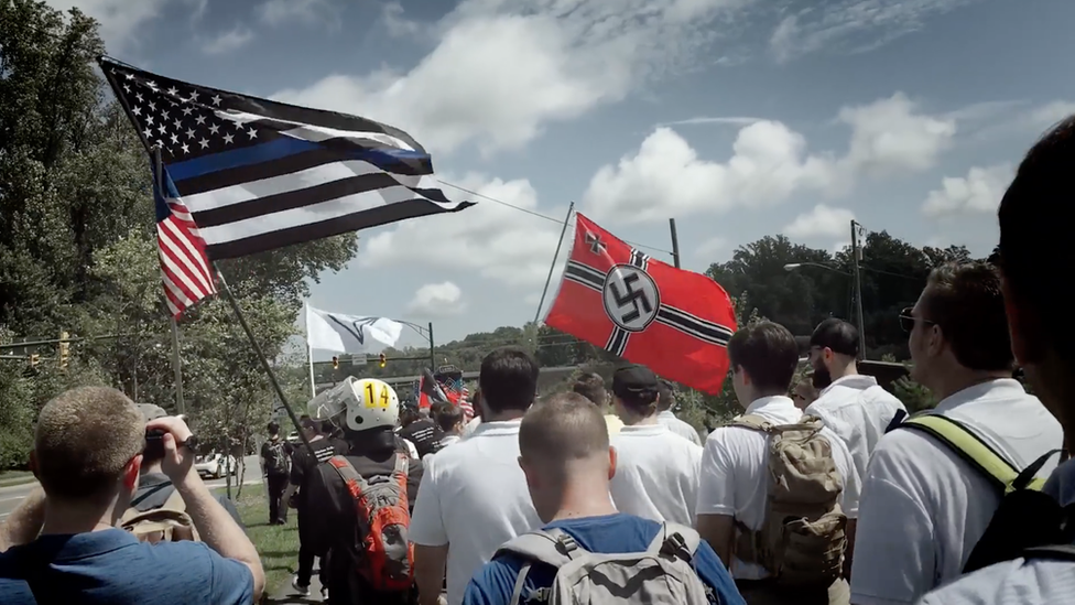 Marchers carrying nazi and US flags. A march in Charlottesville which Patrik Hermansson participated in while undercover