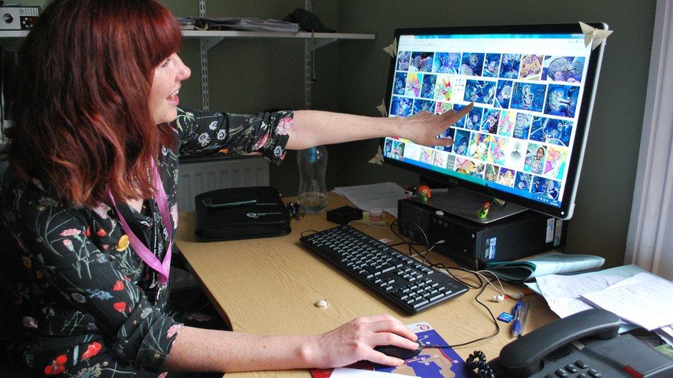 Dr Hanratty pointing to a computer screen with images of 'the tree of life'