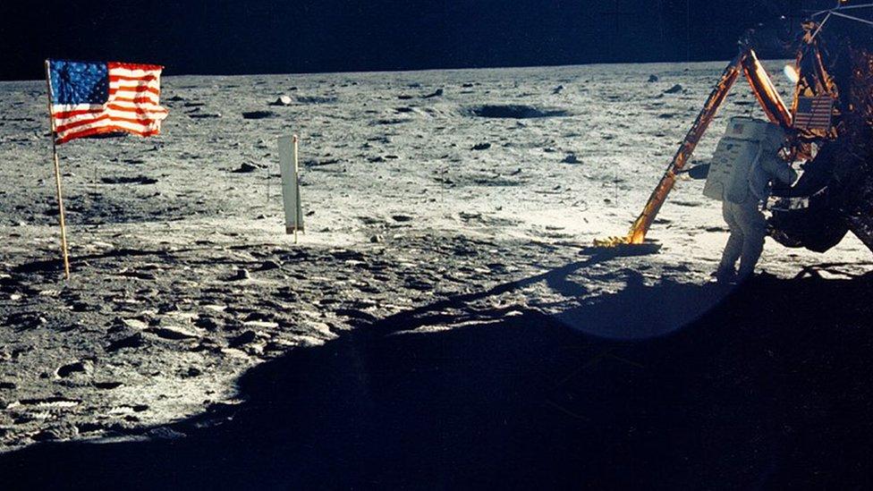 One of the few photographs of Neil Armstrong on the moon shows him working on his space craft on the lunar surface