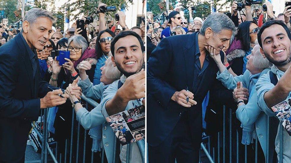 Elfriede Wolf reaches out and grabs George Clooney's face as he walks the red carpet