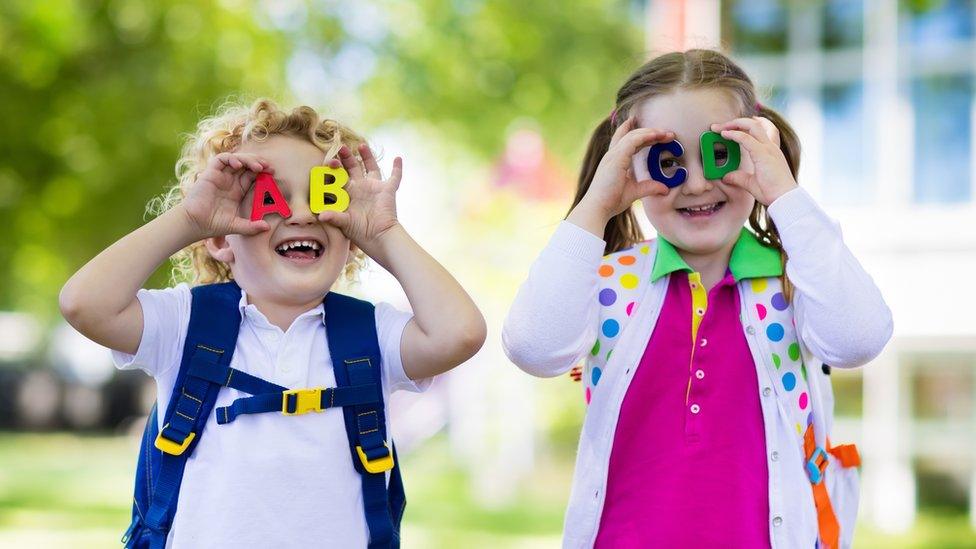 Children play with toy letters